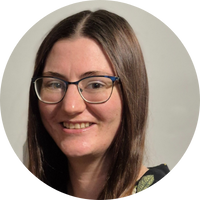 A picture of Claire Turner. Claire has long straight brown hair and is wearing glasses