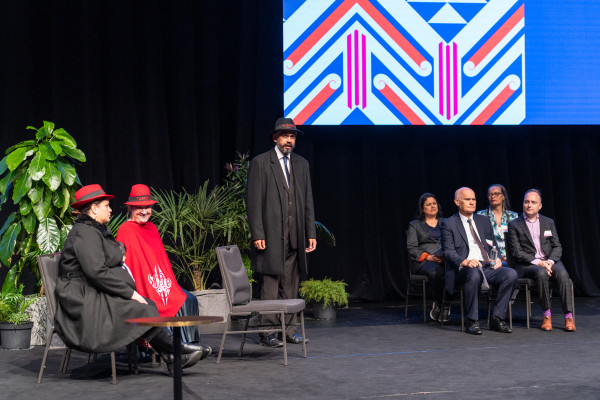 Sitting on the left are mana whenua, Te Taumata Tapu o Ngāi Tūāhuriri who are welcoming everyone with a mihi whakatau on stage. Sitting on the centre stage is left to right: Hon Dr Ayesha Verrall, Dr Peter Jensen, Angie Smith and Deon York.