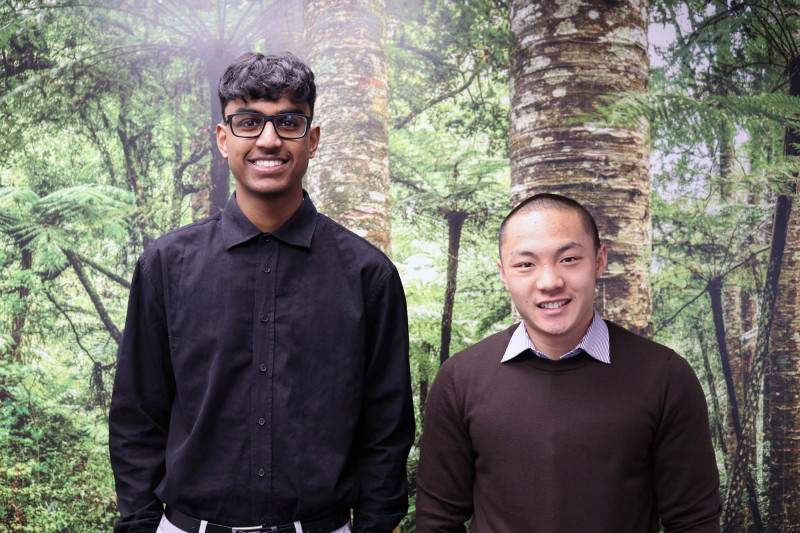 An image of Ranen and Felix standing in front of a forest backdrop.