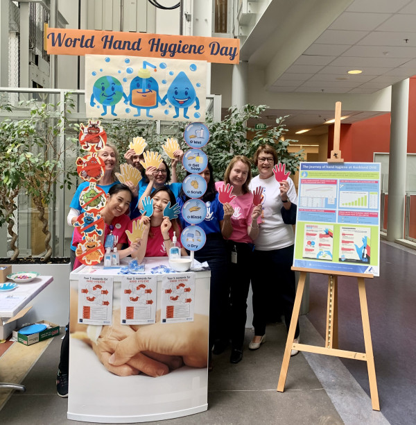 ADHB WHHD hospital foyer stand with hand hygiene graphs and IPC team members 